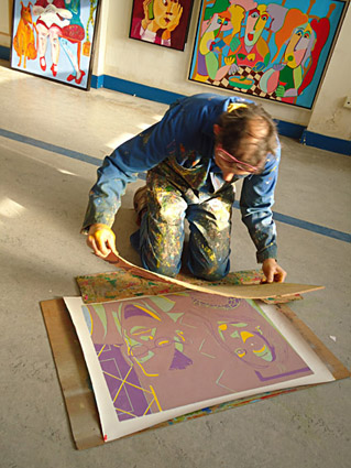 The inked linoleum is put on the print, here are already a number of colors printed.