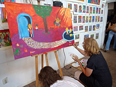 Tijdens een workshop schilderen wordt de laatste hand gelegd aan een schilderij gemaakt met 8 collega's tijdens bedrijfsfeest